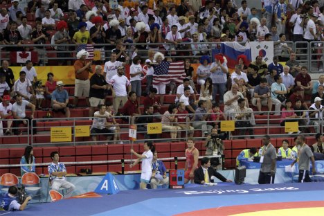 Former Missouri wrestler Ben Askren parades into the Olympic wrestling venue. Notice the Askren-maniacs in the stands, wearing fright wigs to mimick askren's usually wild hairdo.